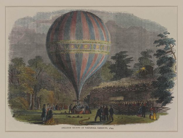 Print. A balloon rises against a night sky above a basket surrounded by people. More look on and stands to our right appear to be full of spectators.